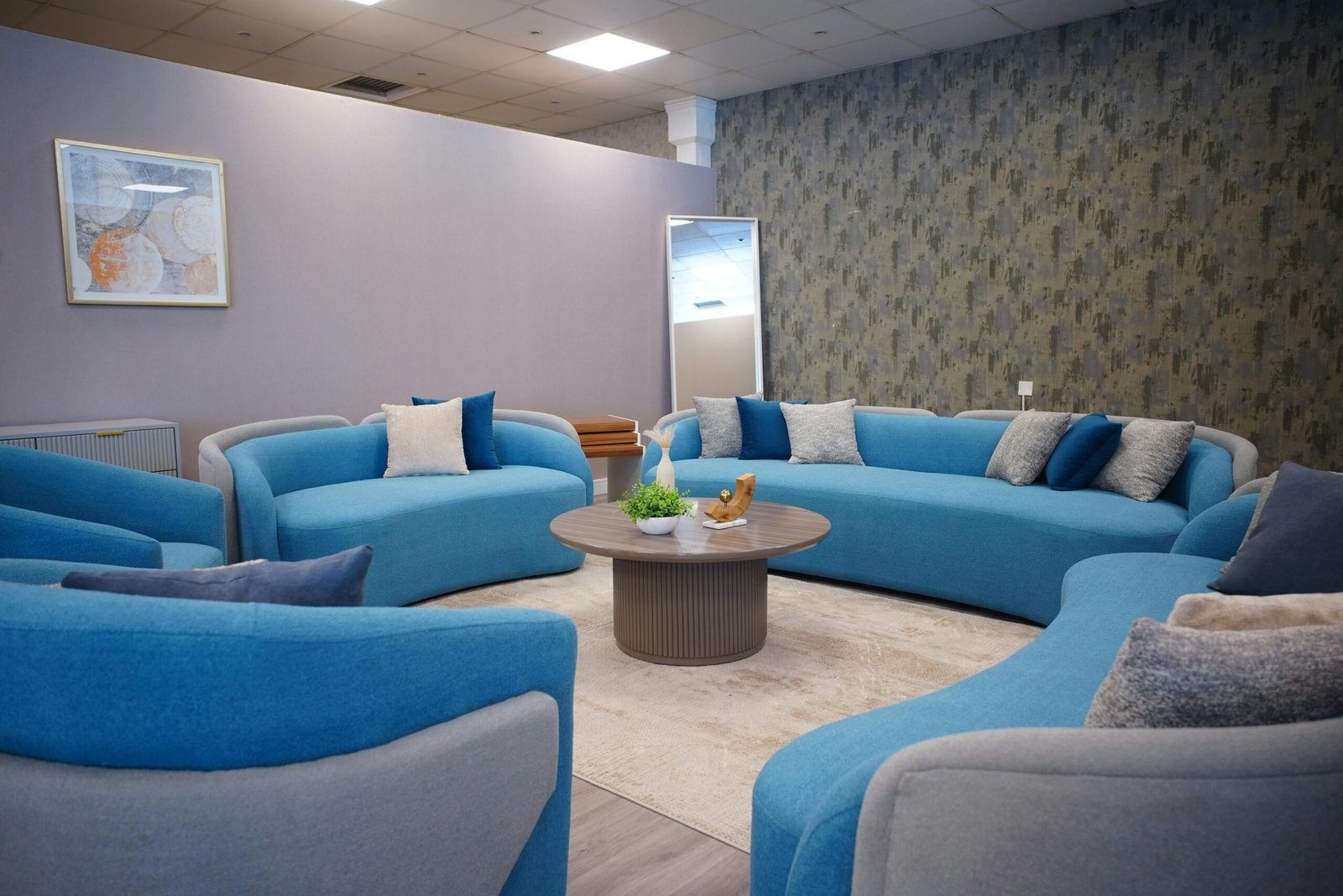 Stylish lounge with modern blue sofas and elegant decor, perfect for cozy gatherings.