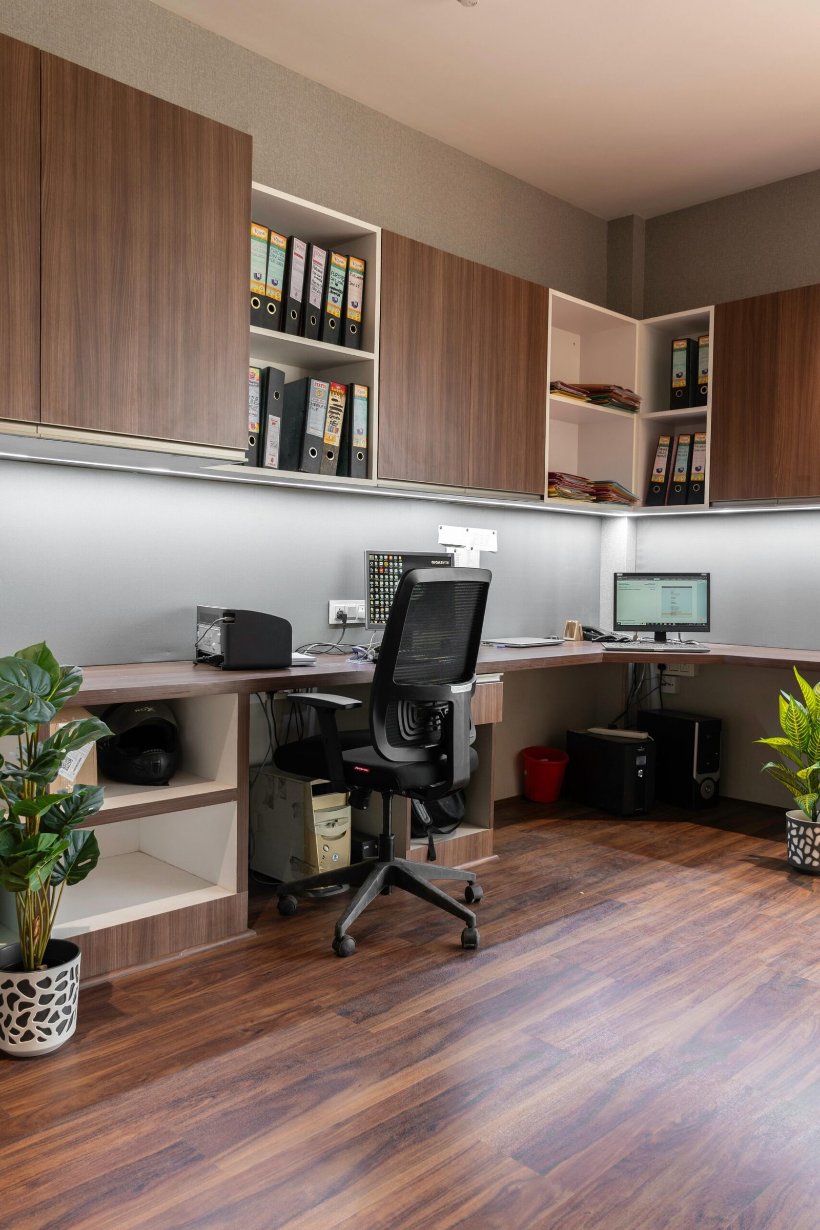 Stylish office setup featuring wooden cabinetry and modern furnishings. Ideal workspace inspiration.