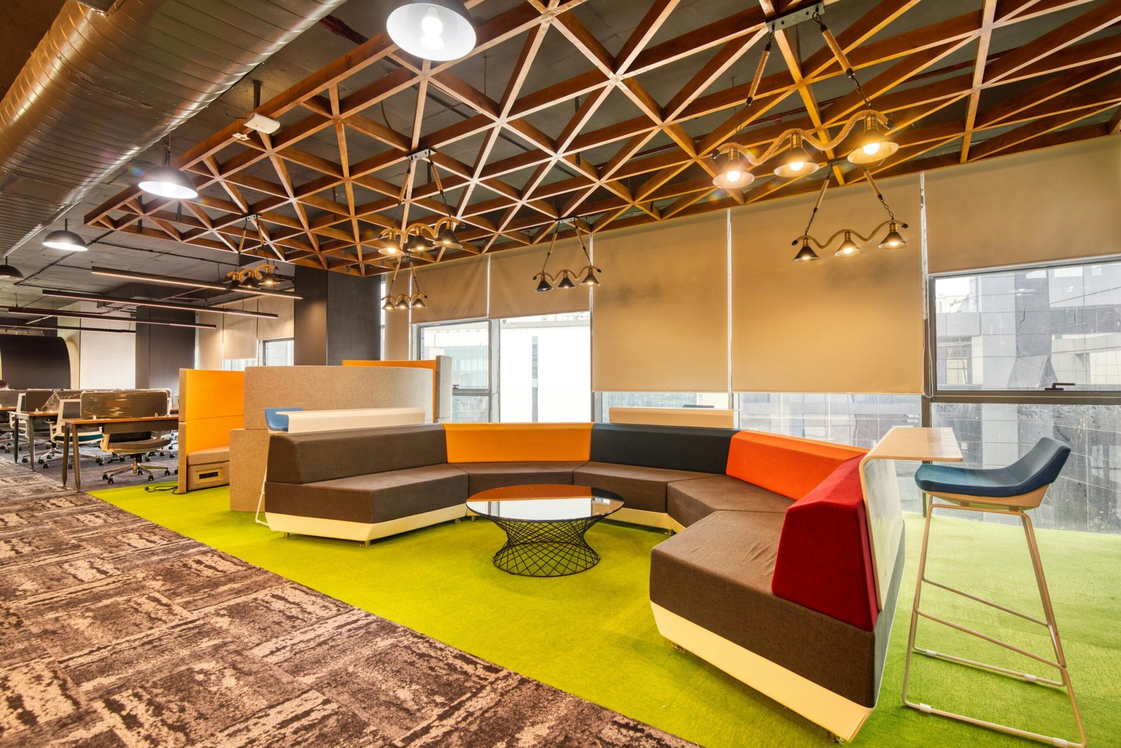Vibrant open office space with colorful seating and contemporary design elements.